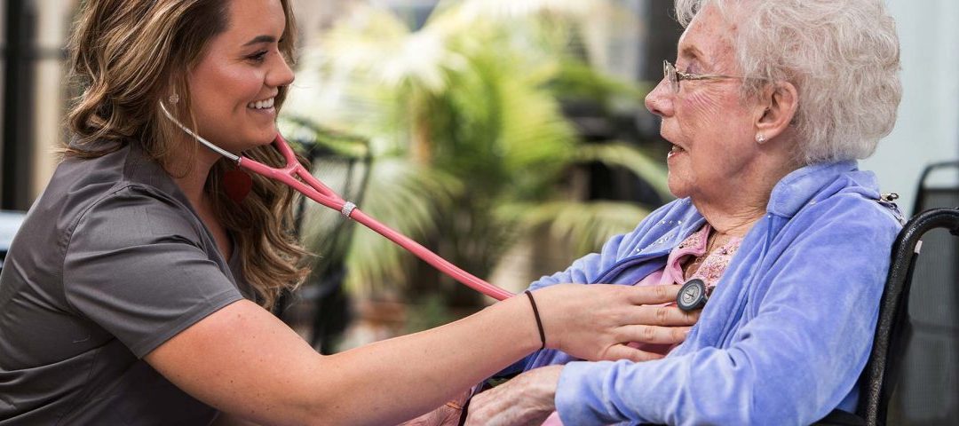 nurse hearing heartbeat of a woman senior